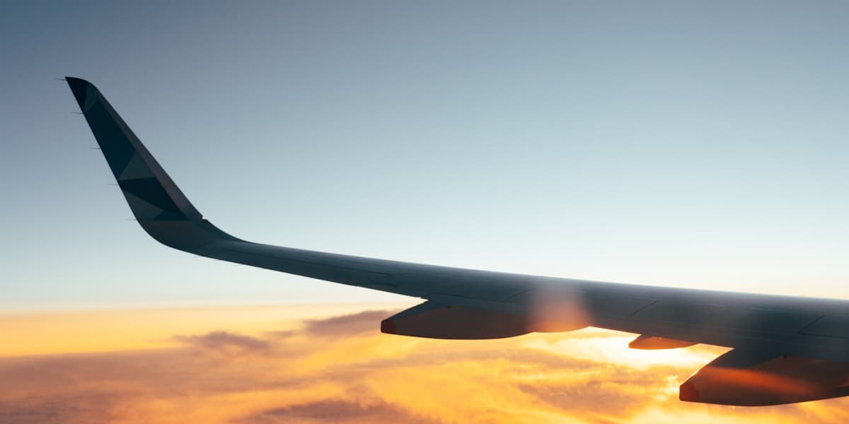 Airplane wing above clouds